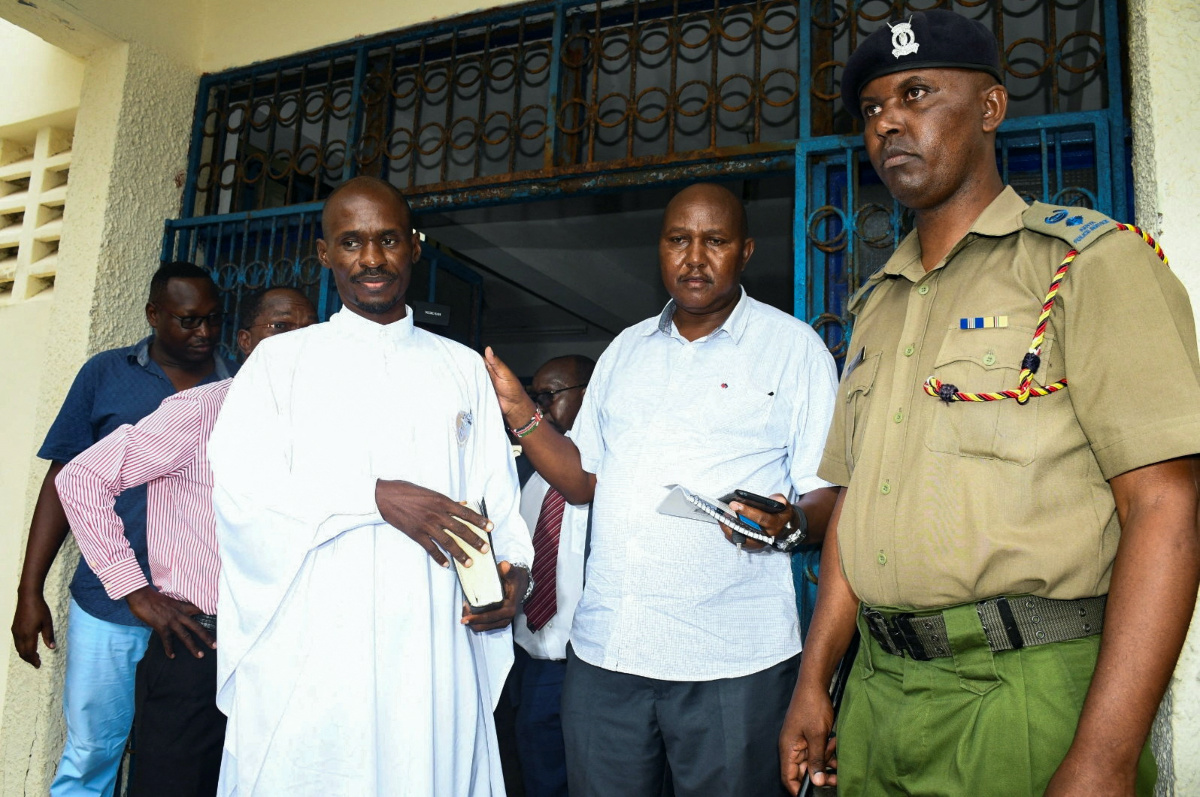 Detectives escort Ezekiel Ombok Odero, the Head of New Life Prayer Centre/Church in Kilifi County,  at the police headquarters for investigations into the Shakahola killings linked to pastor Paul Mackenzie, in Mombasa, Kenya, on 27th April, 2023. 