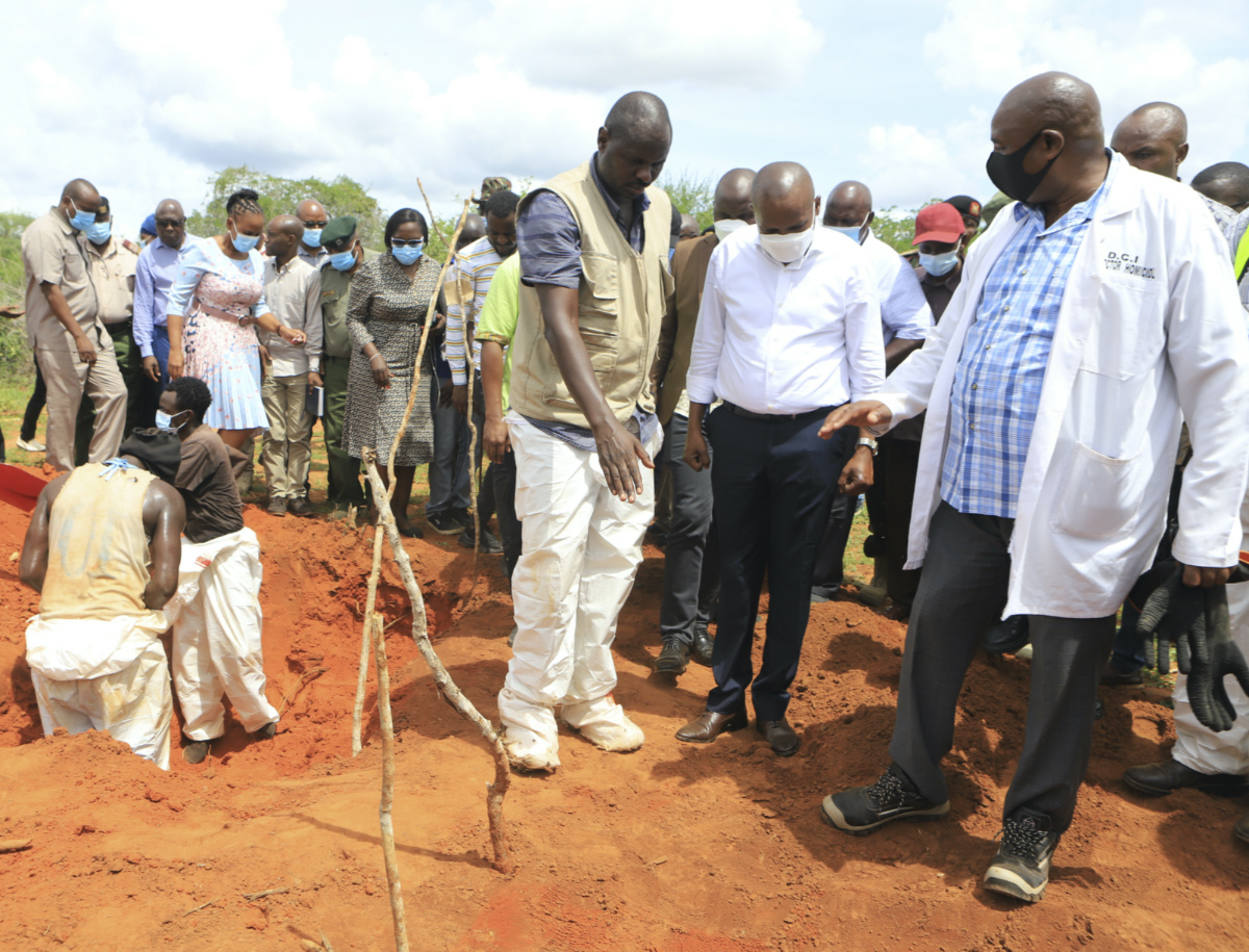 Kenya Interior minister Kithure Kindiki, centre, in white shirt, inspects graves where victims of a Christian cult are buried at a forest in Shakahola, outskirts of tourist town of Malindi, Coastal Kenya, on Tuesday, 25th April, 2023.