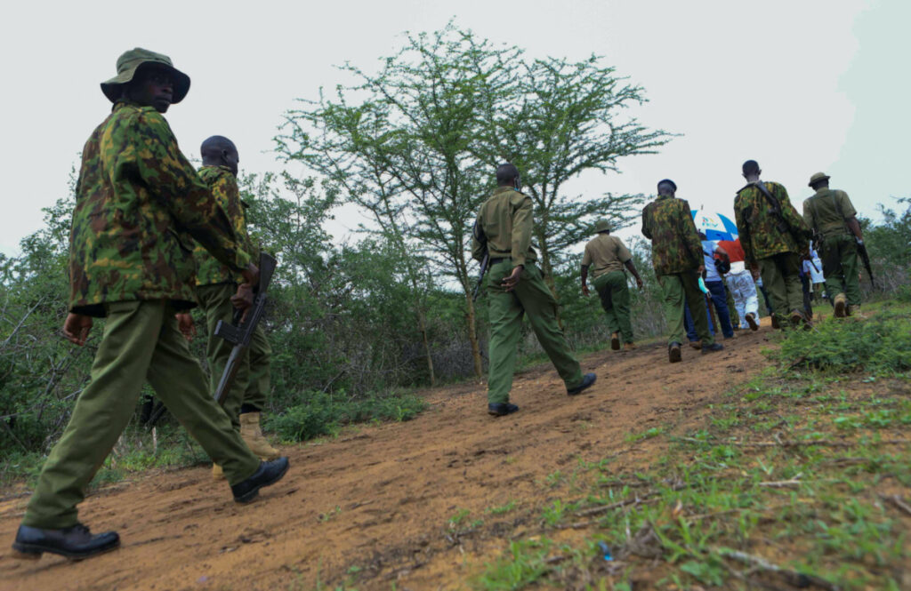 Kenya police officers arrive at the scene where forensic experts and homicide detectives exhume bodies of suspected members of a Christian cult named as Good News International Church, who believed they would go to heaven if they starved themselves to death, in Shakahola forest of Kilifi county, Kenya, on 22nd April, 2023.