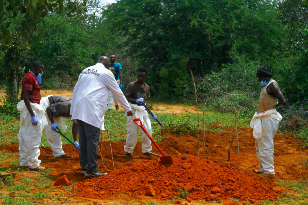 Volunteers assist forensic experts and homicide detectives from the Directorate of Criminal Investigations, to exhume bodies of suspected followers of a Christian cult named as Good News International Church, whose members believed they would go to heaven if they starved themselves to death, in Shakahola forest of Kilifi county, Kenya, on 25th April, 2023.
