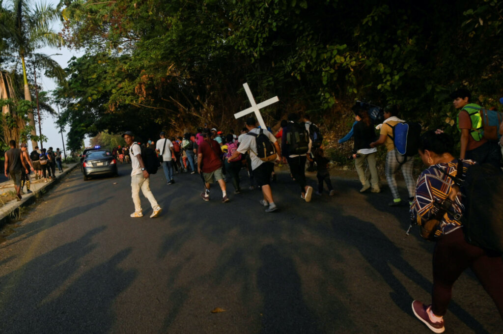 Migrants take part in a caravan towards Mexico City called 'The Migrant's Via Crucis' in memory of the 40 migrants who died during a fire at a migrant detention centre in the border city of Ciudad Juarez, as they walk along the road en route to Viva Mexico, Chiapas state, Mexico, on 23rd April, 2023.