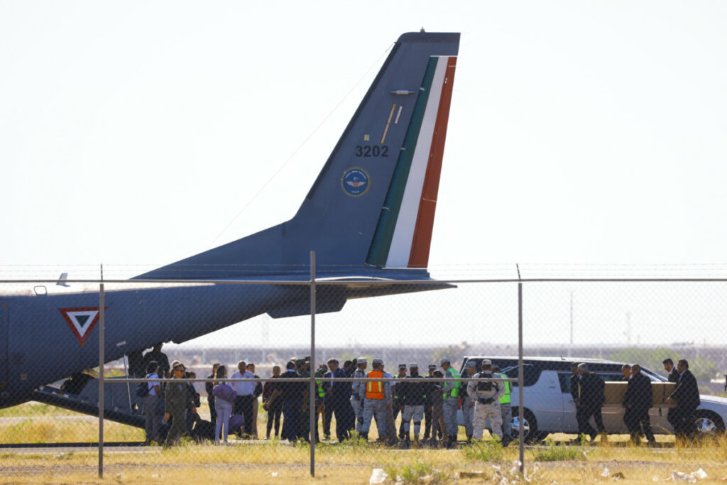 Funeral workers carry a box containing the body of a migrant who died in a fire at a detention centre, onto a plane to be taken to his place of origin in Ciudad Juarez, Mexico, on 11th April, 2023.