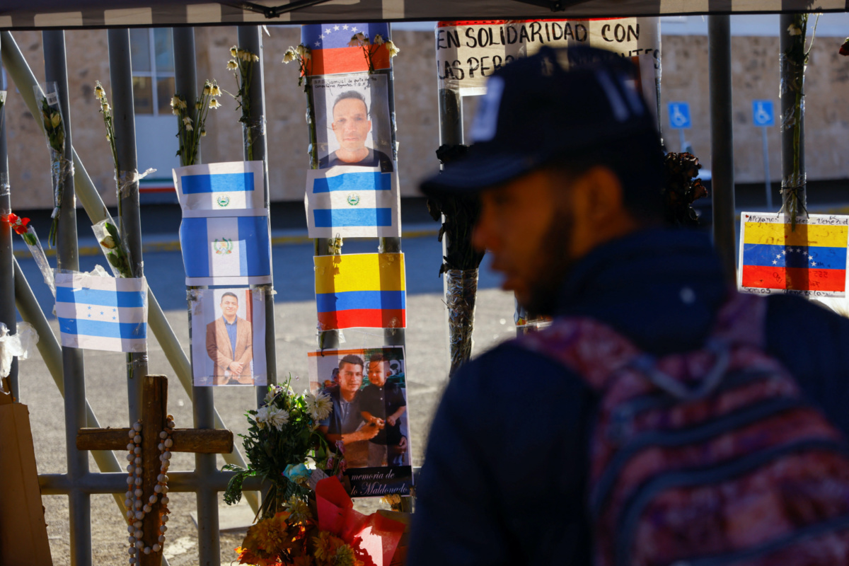 A migrant stands near a makeshift memorial outside the immigration detention centre where several migrants died after a fire broke out late on Monday, in Ciudad Juarez, Mexico, on 31st March, 2023.