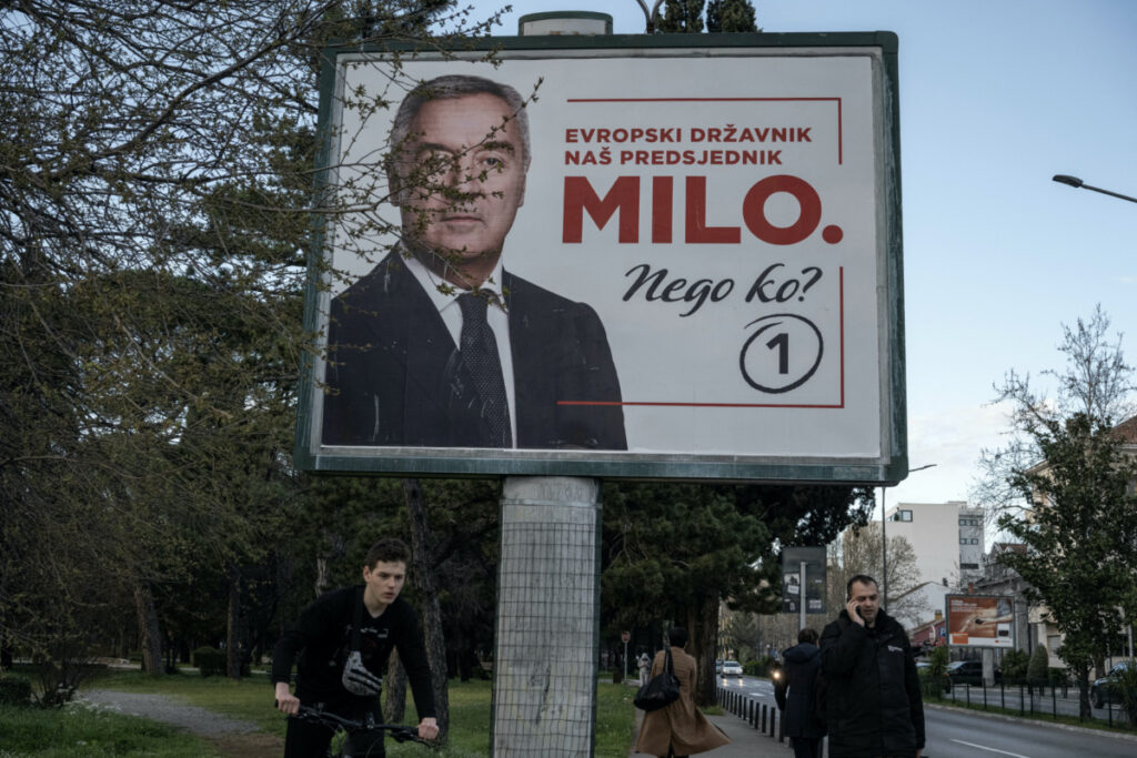 People walk past an election campaign poster of incumbent President Milo Djukanovic in Podgorica, Montenegro, on 1st April, 2023.