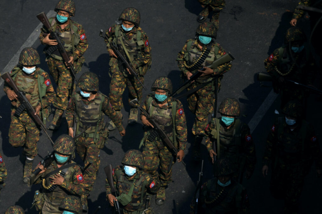Myanmar soldiers from the 77th light infantry division walk along a street during a protest against the military coup in Yangon, Myanmar, on 28th February, 2021.