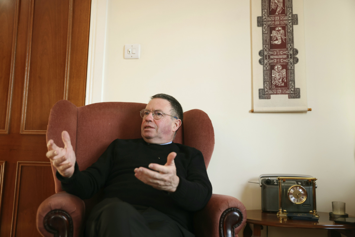Rev Martin Magill, a Catholic priest who co-chairs the 4 Corners Festival, an annual series of events seeking to bring people together across Belfast's religious divide speaks to The Associated Press from his Parish, in west Belfast, Northern Ireland, on Saturday, 28th January, 2023. 