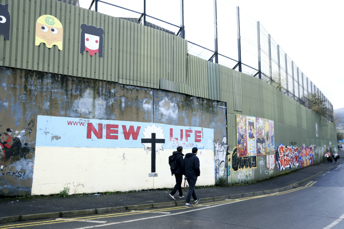 Tourists walk by the peace wall, in west Belfast, Northern Ireland, on Saturday, 28th January, 2023. 