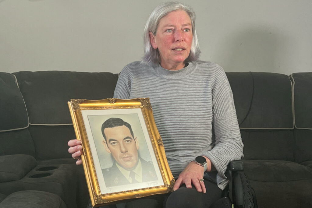 Andrea Brown, daughter of Royal Ulster Constabulary officer Eric Brown who was killed in 1983, holds a portrait of her father in Moira, Northern Ireland, on 29th March, 2023.