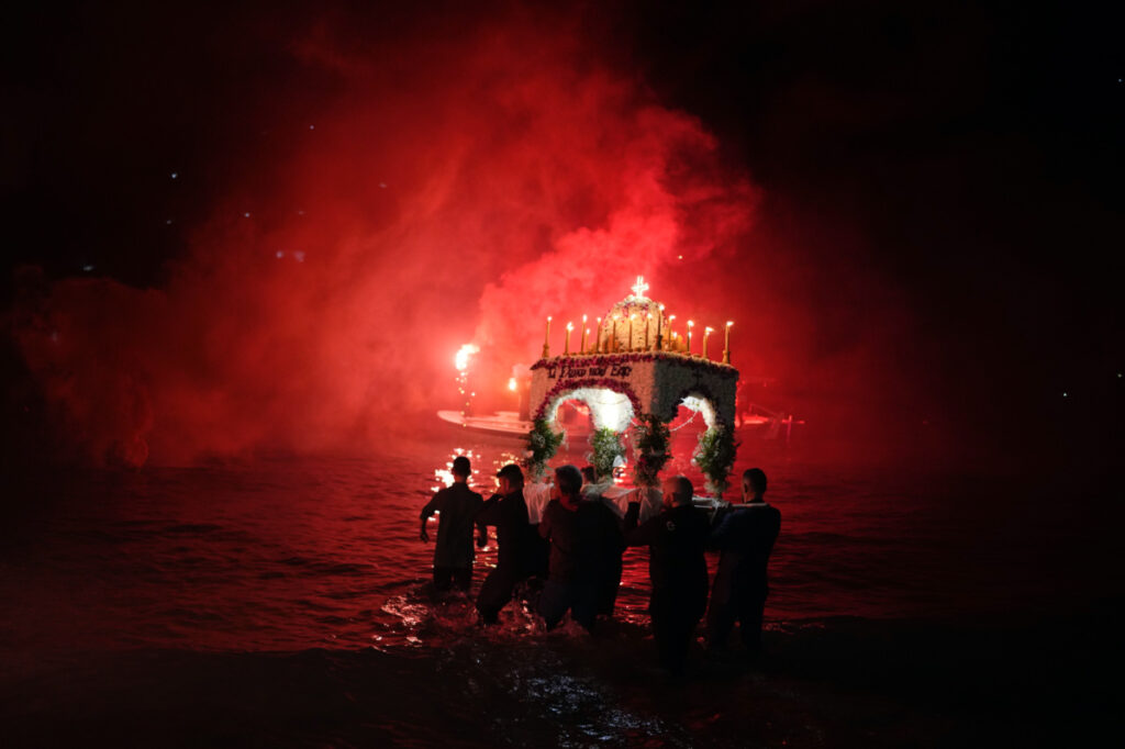 Men carry the Epitaph, the procession of Jesus' funeral bier, into the sea in the town of Tolo, about 150 kilometres south-west of Athens, Greece, on Friday, 14th April, 2023.