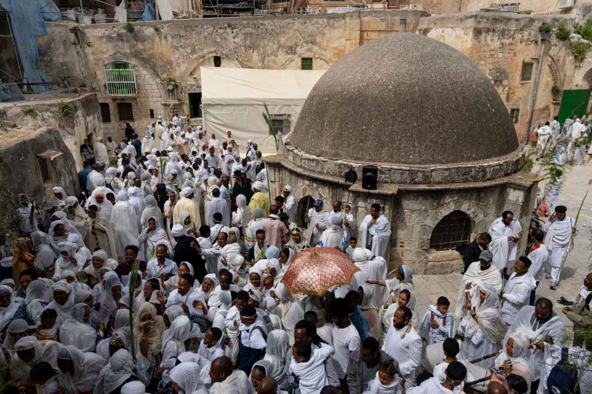 Ethiopian Orthodox Christian worshippers gather for Palm Sunday celebrations at the Ethiopian monks' quarters on the rooftop of the Church of the Holy Sepulchre, the place where Christians believe Jesus Christ was crucified, buried and resurrected, in Jerusalem, on Sunday, 9th April, 2023.