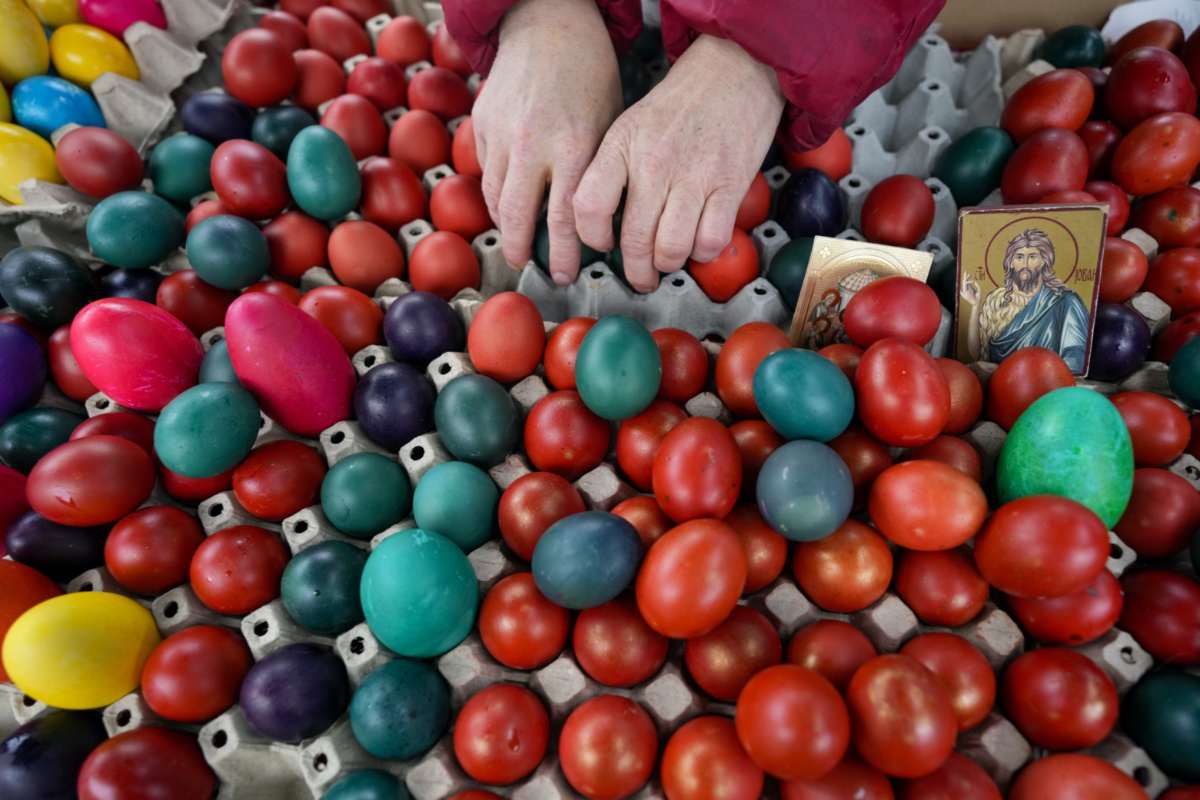 A vendor arranges hand-decorated Easter eggs, on Orthodox Good Friday at a green market, in Belgrade, Serbia, Friday, on 14th April, 2023. 