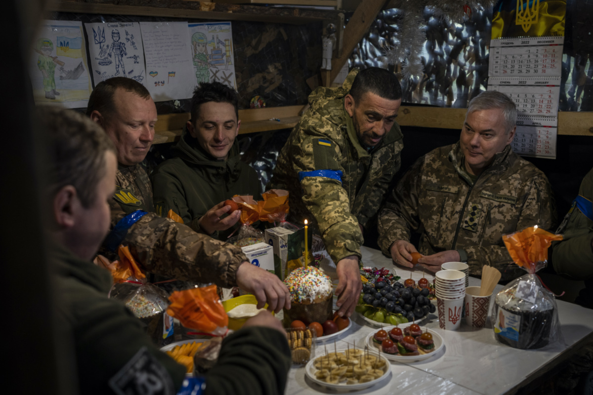 Lieutenant General Serhiy Nayev, Commander of the Joint Forces of the Ukrainian Armed Forces, right, joins an Easter meal with Ukrainian servicemen stationed in a defensive post in Kyiv region, on Saturday, 15th April, 2023.