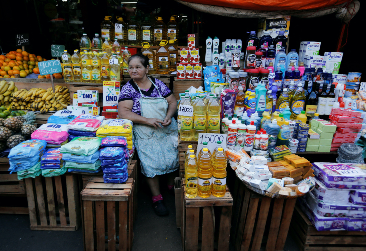 A woman sits among the products she sells from her stall at the Mercado 4 street market ahead of Paraguay's national election, in Asuncion, Paraguay, on 28th April, 2023. 