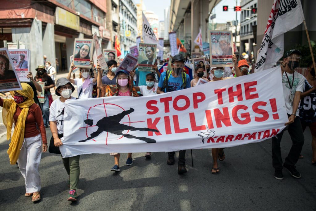Protesters calling to stop extra-judicial killings march towards the presidential Malacanang Palace during a protest to commemorate President Rodrigo Duterte's final year in office, in Manila, Philippines, on 30th June, 2021.