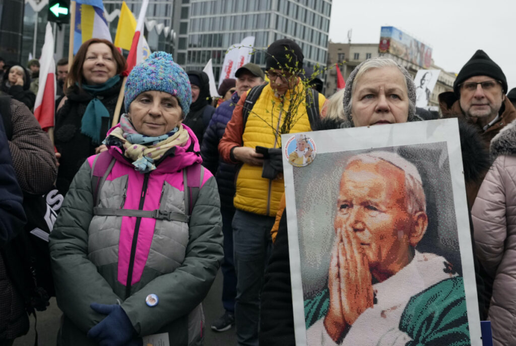 People take part in a march in defense of the late pope, St. John Paul II, in Warsaw, Poland, Sunday, 2nd April, 2023.