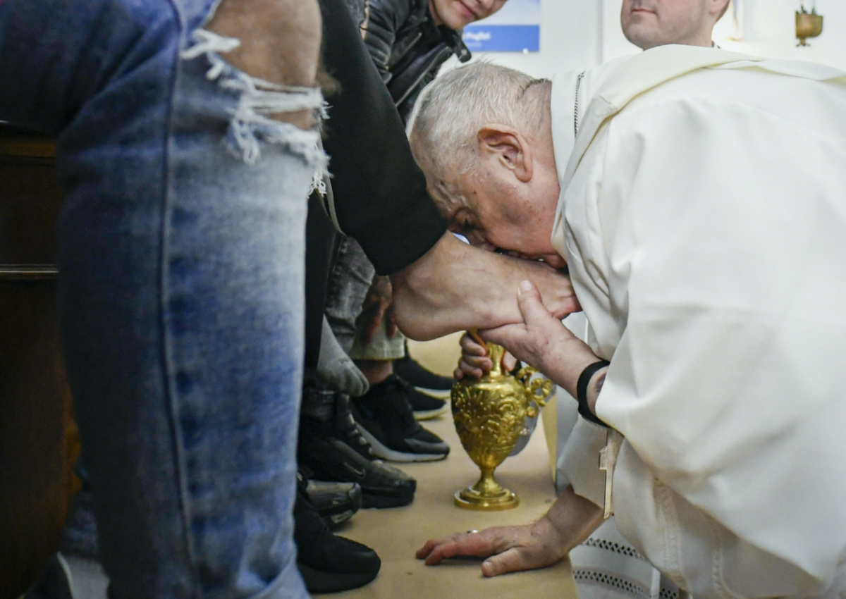In this picture made available by Vatican Media Pope Francis kisses the feet of the inmates of Rome's penitentiary of Casal del Marmo, on Thursday, 6th April, 2023. 