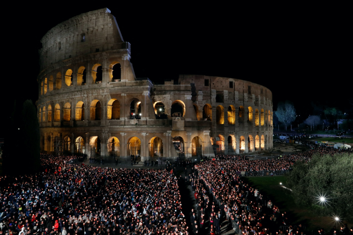 People attend the Via Crucis procession during Good Friday celebrations at the Colosseum, which Pope Francis follows from Casa Santa Marta at the Vatican due to the intense cold, in Rome, Italy, on 7th April, 2023.