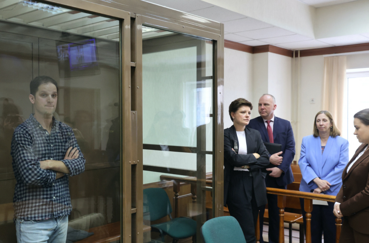 Wall Street Journal reporter Evan Gershkovich, who was detained in March while on a reporting trip and charged with espionage, stands behind a glass wall of an enclosure for defendants, while US Ambassador to Russia Lynne Tracy and lawyers Tatyana Nozhkina and Maria Korchagina appear in a courtroom before a hearing to consider an appeal against Gershkovich's detention, in Moscow, Russia, on 18th April, 2023