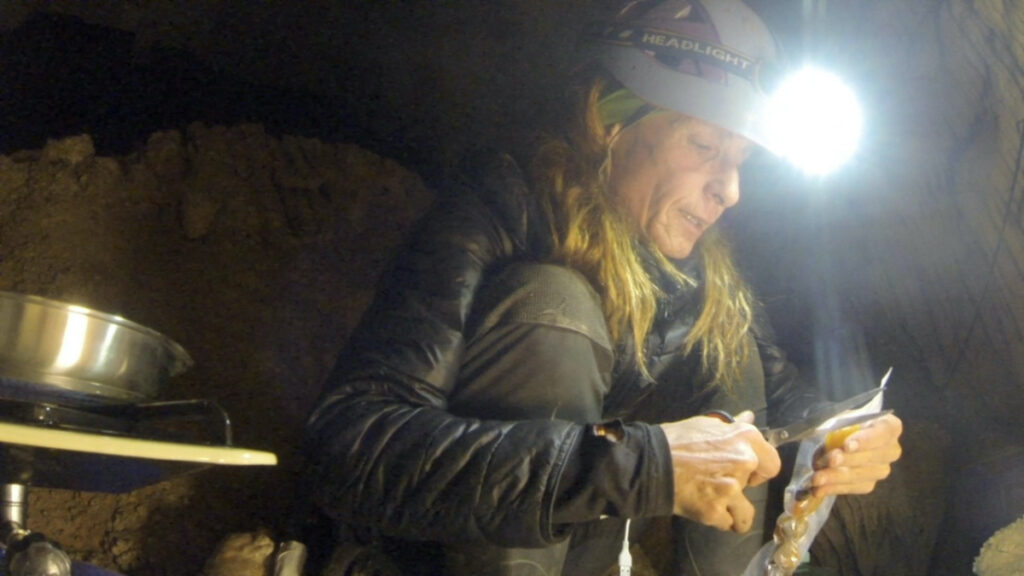 Beatriz Flamini, a Spanish mountaineer who has been isolated for 500 days in a cave is pictured during her daily life at the cave in Motril, Spain in this screen grab taken from a handout video in November 2021.