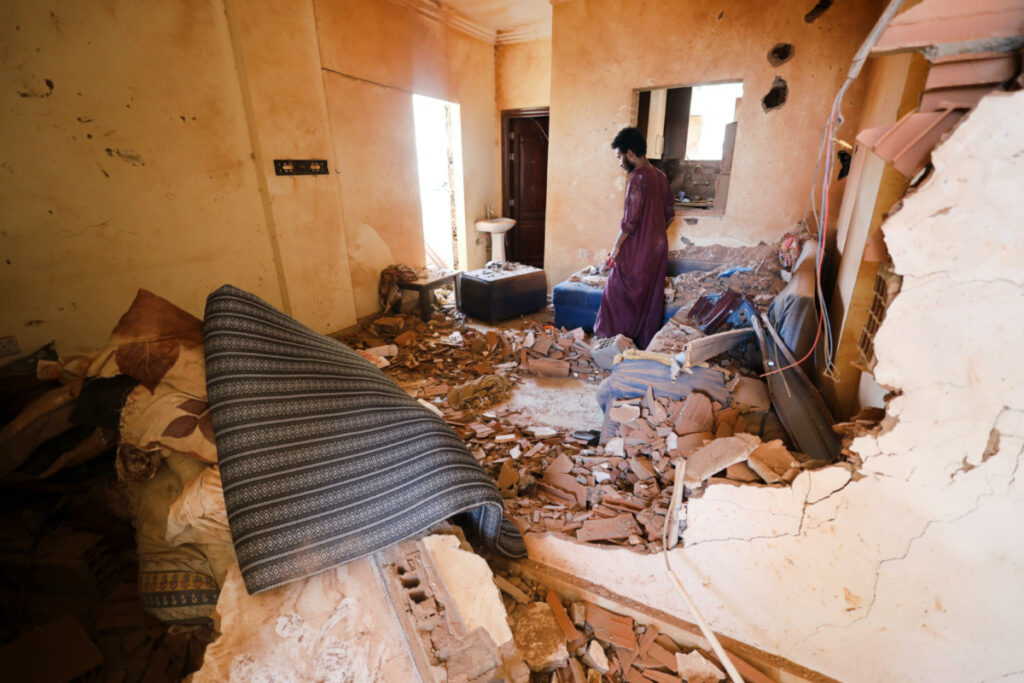 A man looks at belongings inside a damaged house during clashes between the paramilitary Rapid Support Forces and the army in Khartoum, Sudan, on 17th April 2023.