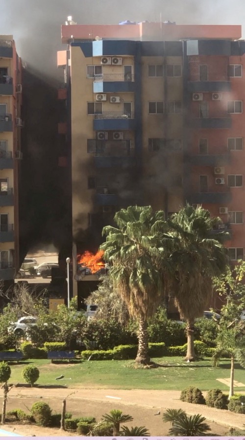 Smoke and fire rise from an apartment building in a residential complex, after a shell hit the building according to eyewitness, in Khartoum, Sudan on 19th April, 2023, in this still image obtained from a social media video