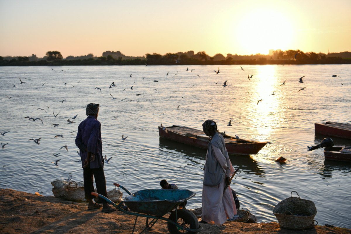 Sudanese traders await the arrival of fishermen with the day’s catches by the Nile River bank in Omdurman, Sudan, on 11th February 2023. 