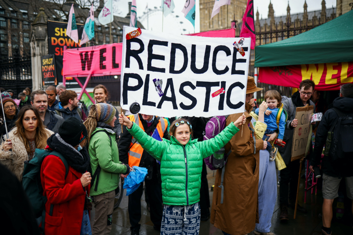 Laurelin Bartlett holds up a banner as activists protest during the Extinction Rebellion's 'The Big One' event, in London, Britain, on 21st April 2023.