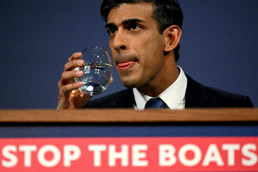 British Prime Minister Rishi Sunak drinks water during a press conference following the launch of new legislation on migrant channel crossings at Downing Street on 7th March, 2023 in London, United Kingdom.