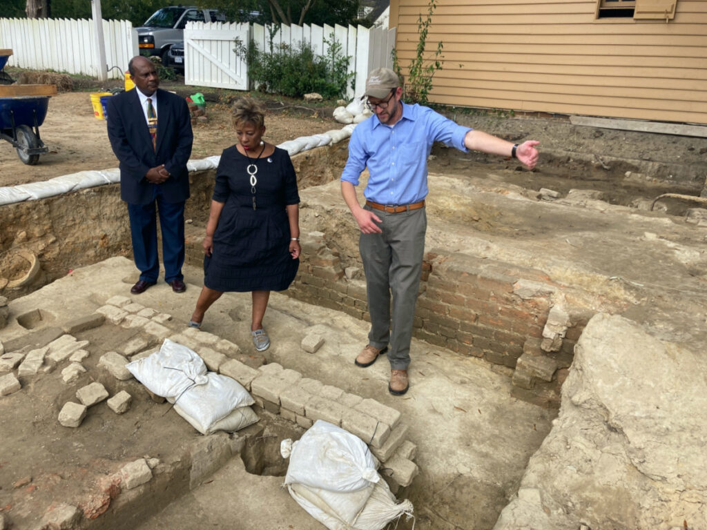 From left, Reginald F. Davis, pastor of First Baptist Church, Connie Matthews Harshaw, a member of First Baptist, and Jack Gary, Colonial Williamsburg's director of archaeology, stand at the brick-and-mortar foundation of one the oldest Black churches in the US on 6th October, 2021, in Williamsburg, Virginia.