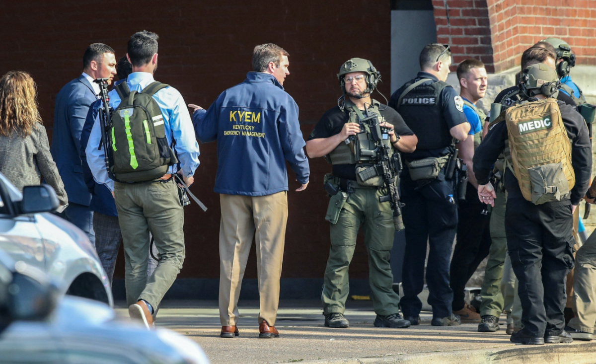 Kentucky Governor Andy Beshear speaks with police deploying at the scene of a mass shooting near Slugger Field baseball stadium in downtown Louisville, Kentucky, US, on 10th April, 2023.