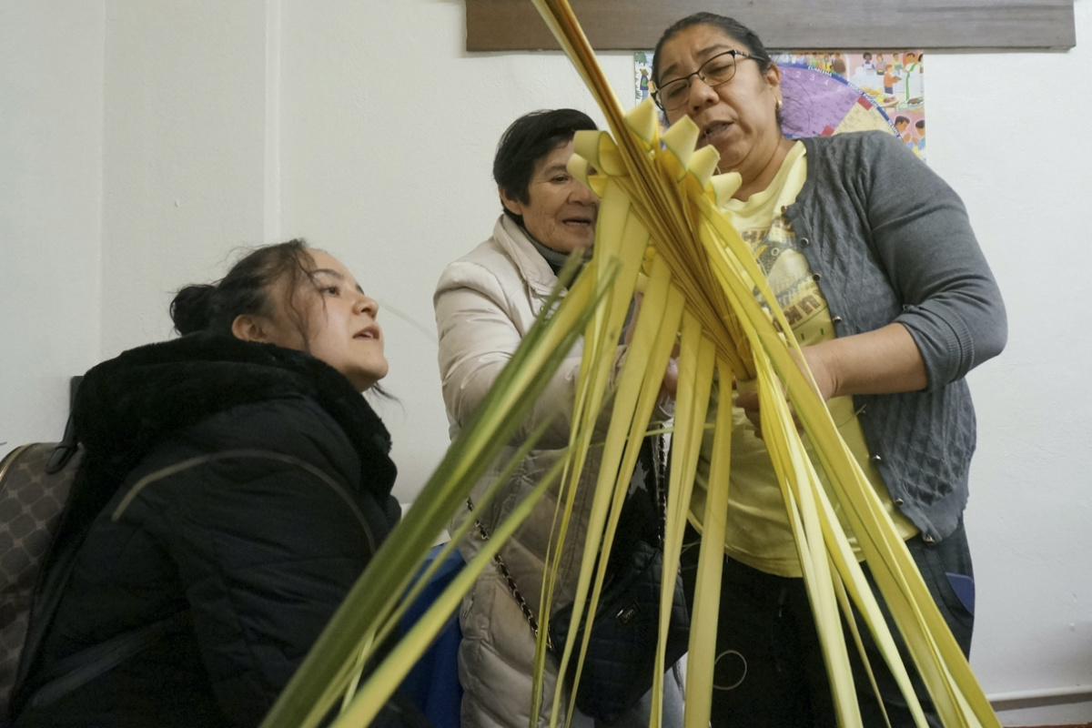 Isabel Tenorio, right, teaches how to weave palm fronds into elaborate designs to Kari Mendoza, left, and her mother, Maria Teresa Mendoza, at the Church of the Incarnation in anticipation of Palm Sunday in Minneapolis on Wednesday, 29th March, 2023. 