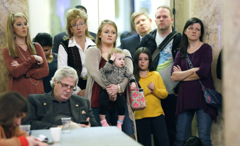 Parents with their children and medical professionals listen to testimony from proponents for allowing exemption from the vaccination requirement for school attendance based on religious beliefs during a meeting of House Judiciary B Committee, on 24th January 2018, at the Capitol in Jackson, Mississippi.