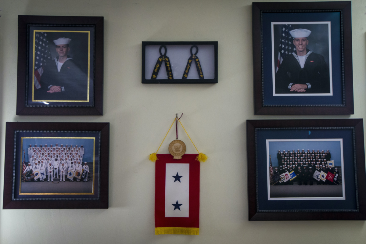 Robert Decker displays photographs to honour the US Navy service of both of his sons, Kyle and Kody, at his home in Norfolk, Virginia, on Tuesday, 14th March, 2023. 