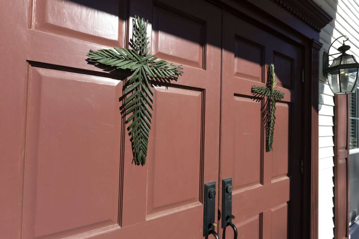 Palm leaf crosses hang on the entrance doors to Parish Presbyterian Church for a Palm Sunday service on Sunday, 2nd April, 2023, in Franklin, Tennessee. 