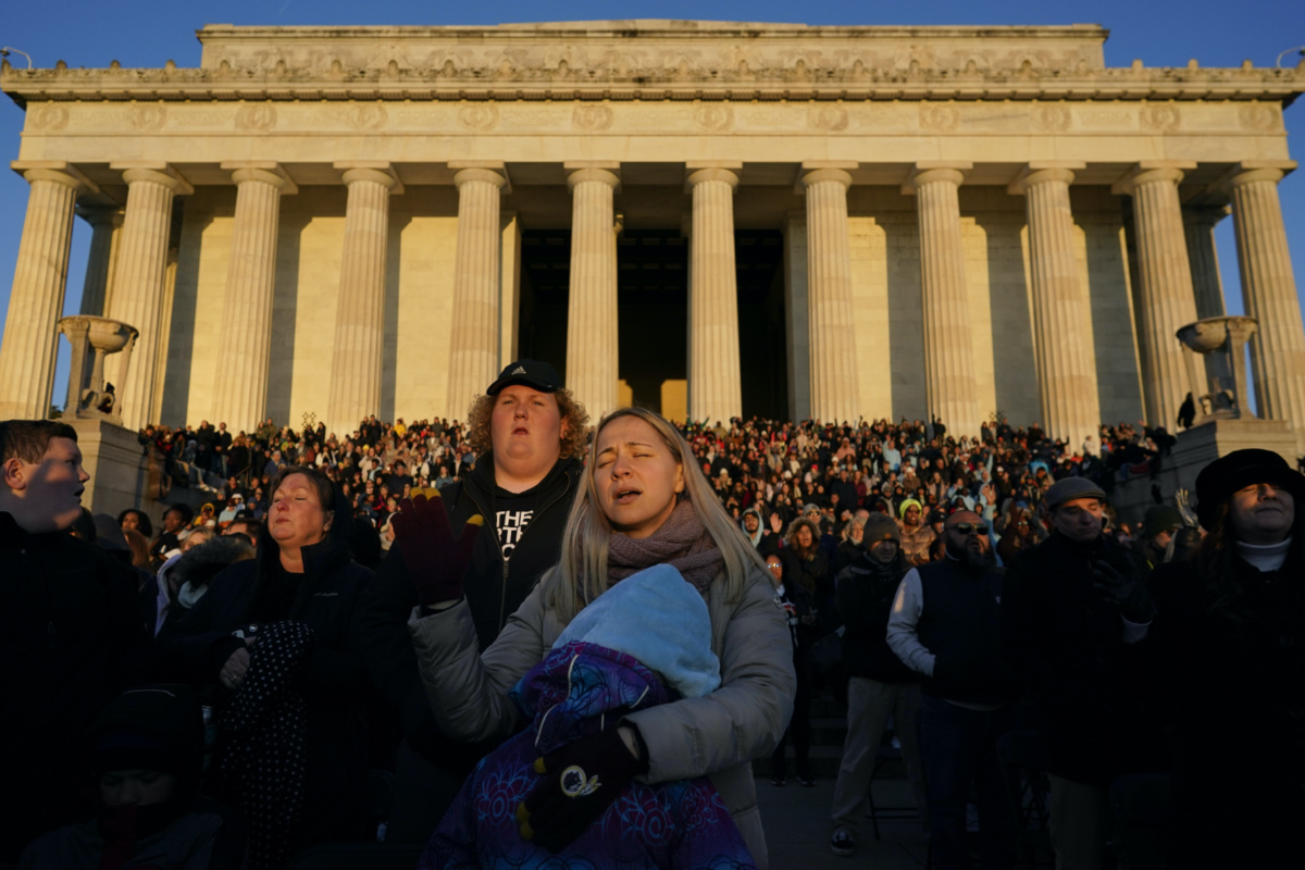 People gather and sing songs of worship during an "Easter Sunrise Service" at the Lincoln Memorial, on Sunday, 9th April, 2023, in Washington, hosted by the National Community Church