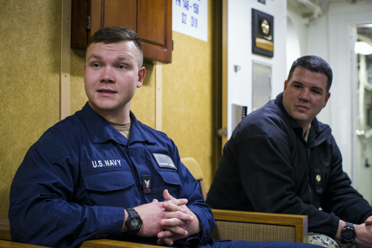 Petty Officer Third Class (PO3) Benjamin Dumas, left, alongside Navy Chaplain Lt. Cmdr. Nathan Rice speak about the "lay leader" aboard the USS Gravely on Tuesday, March 14, 2023 at Norfolk Naval Station in Norfolk, Va. Dumas is a prospective lay leader saying that he wants to serve his shipmates aboard the Gravely. “I’ve seen a lot of brokenness,” he says. (AP Photo/John C. 