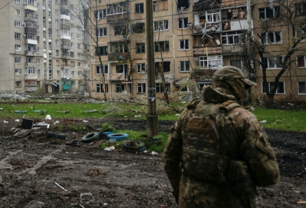 A Ukrainian service member walks near residential buildings damaged by a Russian military strike, amid Russia's attack on Ukraine, in the front line town of Bakhmut, in Donetsk region, Ukraine on 21st April, 2023.