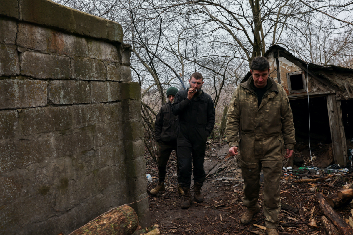 Ukrainian tank unit crew members walk after emerging from a bunker where they took cover from shelling, amid Russia's invasion of Ukraine, near the bombed-out eastern Ukrainian city of Bakhmut, in the eastern Donetsk region, Ukraine, on 29th March, 2023. PICTURE: Reuters/Violeta Santos Moura