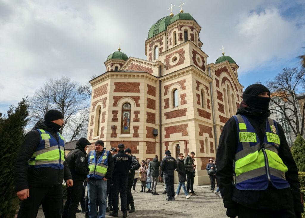 Ukrainian police officers stand next to St George's Cathedral of the Ukrainian Orthodox Church, accused of being linked to Moscow, amid Russia's attack on Ukraine, in Lviv, Ukraine, on 5th April, 2023.