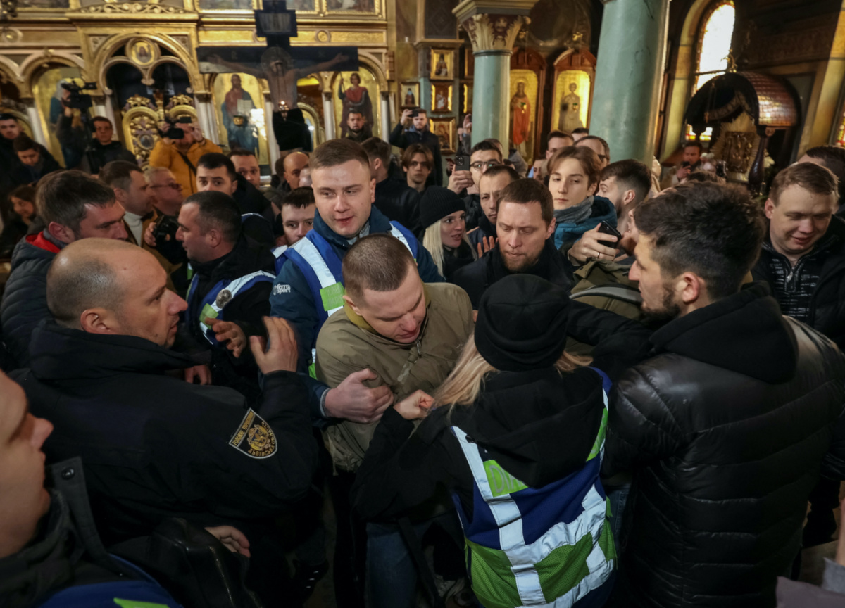 Police separate supporter of the Orthodox Church of Ukraine and believers of the Ukrainian Orthodox Church, accused of being linked to Moscow, in St. George's Cathedral, amid Russia's attack on Ukraine, in Lviv, Ukraine, on 5th April, 2023. 
