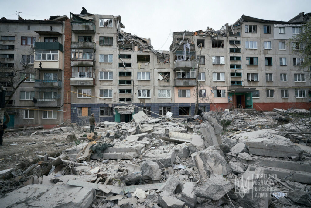 A man stands next to a residential building damaged by a Russian military strike, amid Russia's attack on Ukraine, in Sloviansk, Donetsk region, Ukraine, on 14th April , 2023.