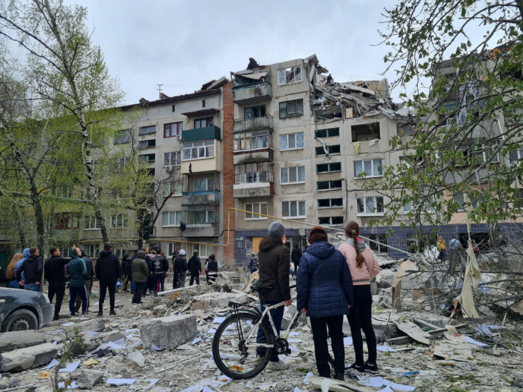 Local residents stand next to an apartment building damaged by a Russian military strike, amid Russia's attack on Ukraine, in Sloviansk, Donetsk region, Ukraine, on 14th April, 2023