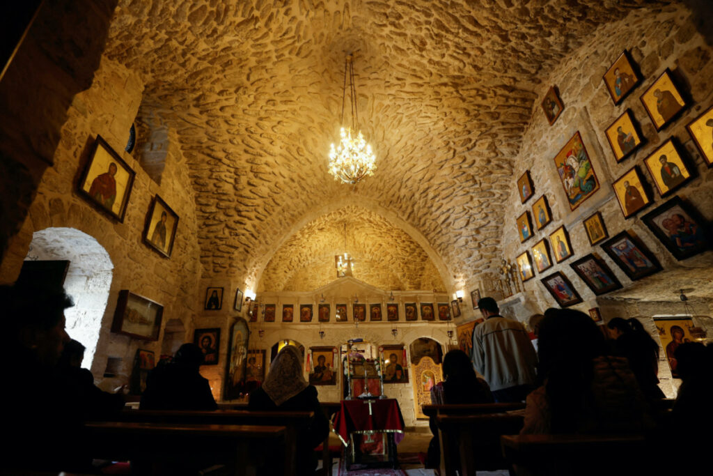 Christian worshippers pray during Mass inside St. George Church, also known as the Church of the Ten Lepers, in Burqin, near Jenin, in the Israeli-occupied West Bank on 31st March, 2023.