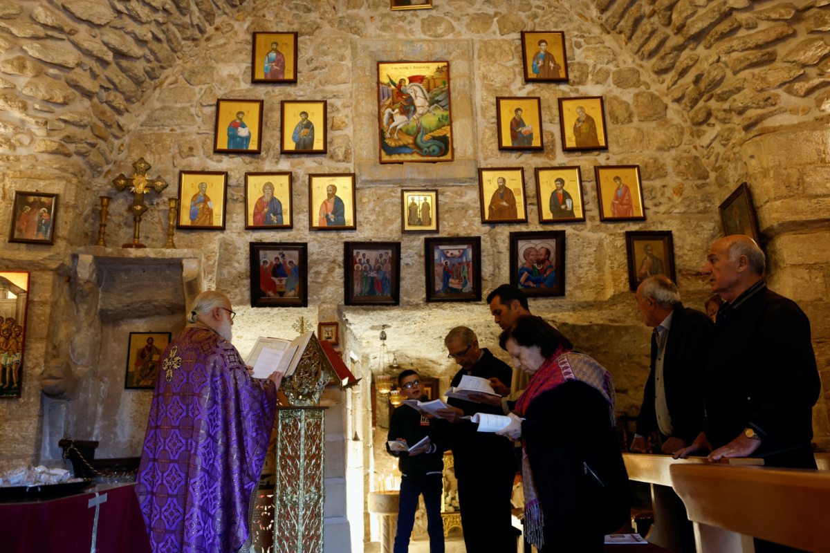 Christian worshippers pray during Mass inside St George Church, also known as the Church of the Ten Lepers, in Burqin, near Jenin, in the Israeli-occupied West Bank on 31st March, 2023. 