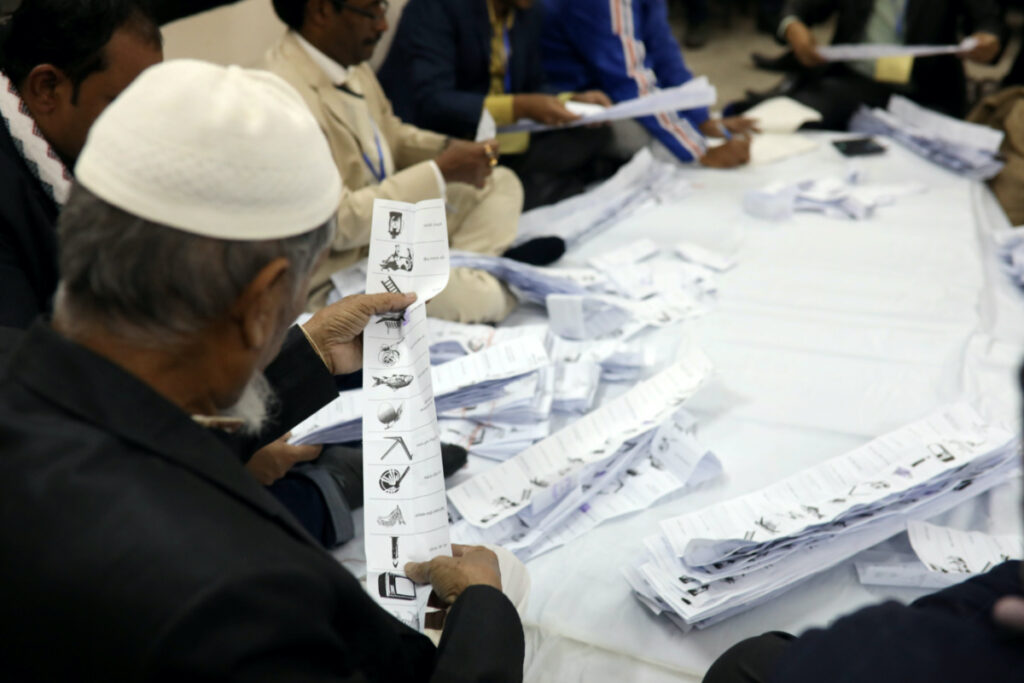 A presiding officer counts votes at a voting center after the session has ended in Dhaka, Bangladesh, on 30th December, 2018.