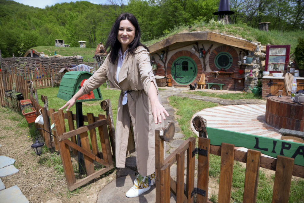 Milijana Milicevic stands in front of the hobbit house named "Lipa", in the Bosnian Hobbiton village, Rakova Noga, Bosnia and Herzegovina, on 9th May, 2023