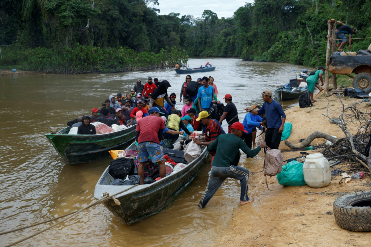 People who were working in illegal mining arrive in boats at Porto do Arame after leaving the Yanomami indigenous land, in Alto Alegre, Roraima state, Brazil, on 12th February, 2023