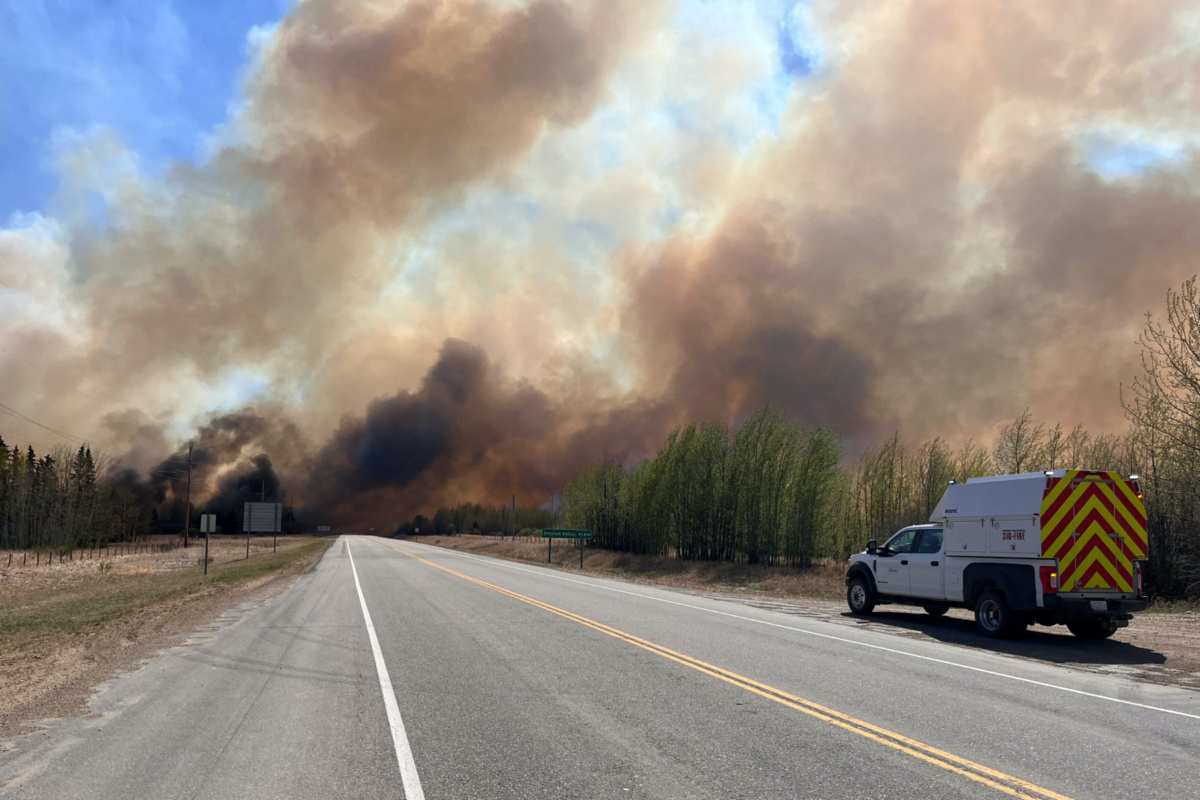 A smoke column rises from wildfire WCU001 near Wildwood, Alberta, Canada, on 5th May, 2023. 