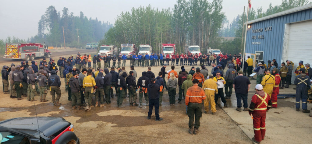 Firefighters gather for a morning briefing at Rainbow Lake Fire Hall before heading out to tackle the Long Lake wildfire HWF036, in Rainbow Lake, Alberta, Canada, on 18th May, 2023.