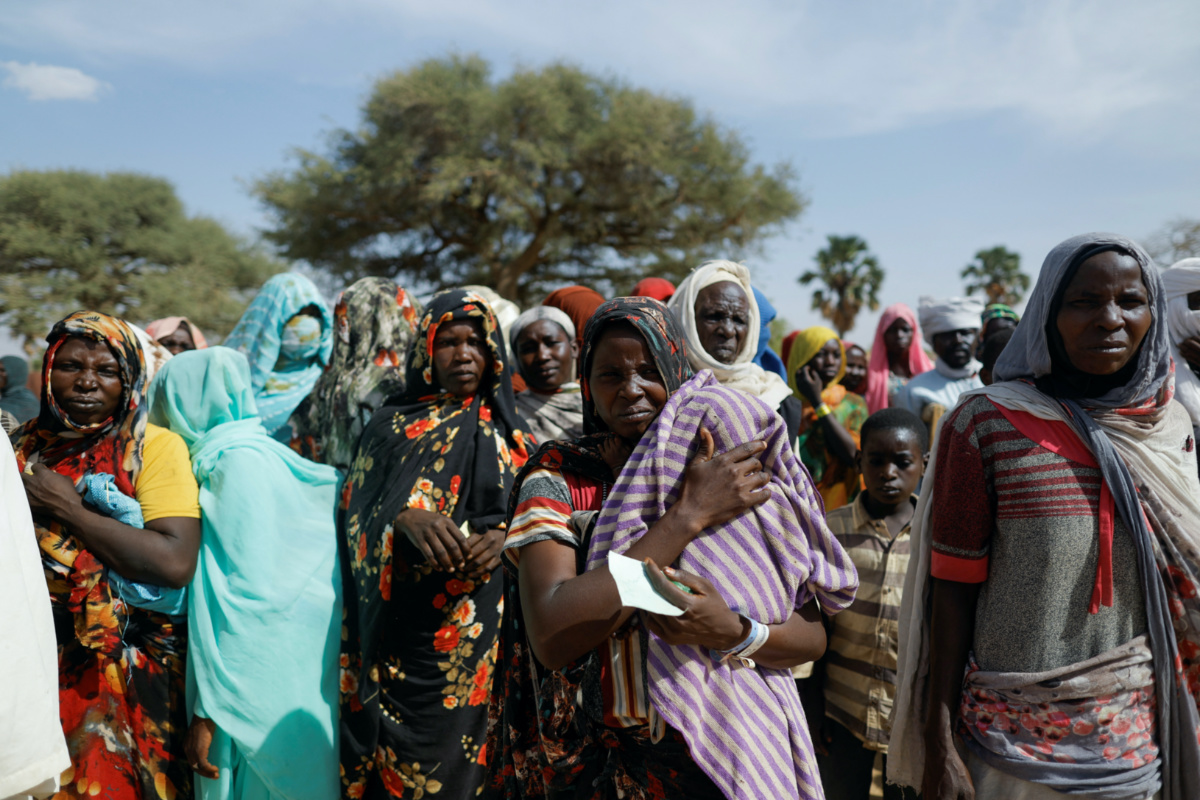 Sudanese refugees, who fled the violence in their country, wait to receive food supplies from a Turkish aid group near the border between Sudan and Chad in Koufroun, Chad, on 7th May, 2023.